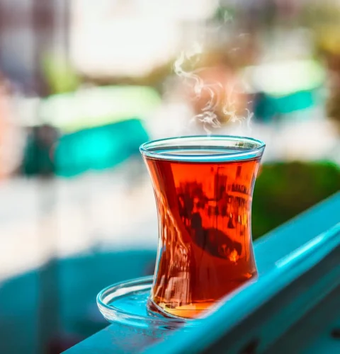 pexels-photo-1493079-1493079 A steaming cup of Turkish tea on a windowsill with blurred background in Gaziantep.