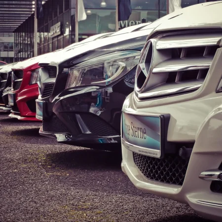 pexels-photo-164634-164634 Luxury cars lined up at an outdoor dealership, showcasing sleek designs.