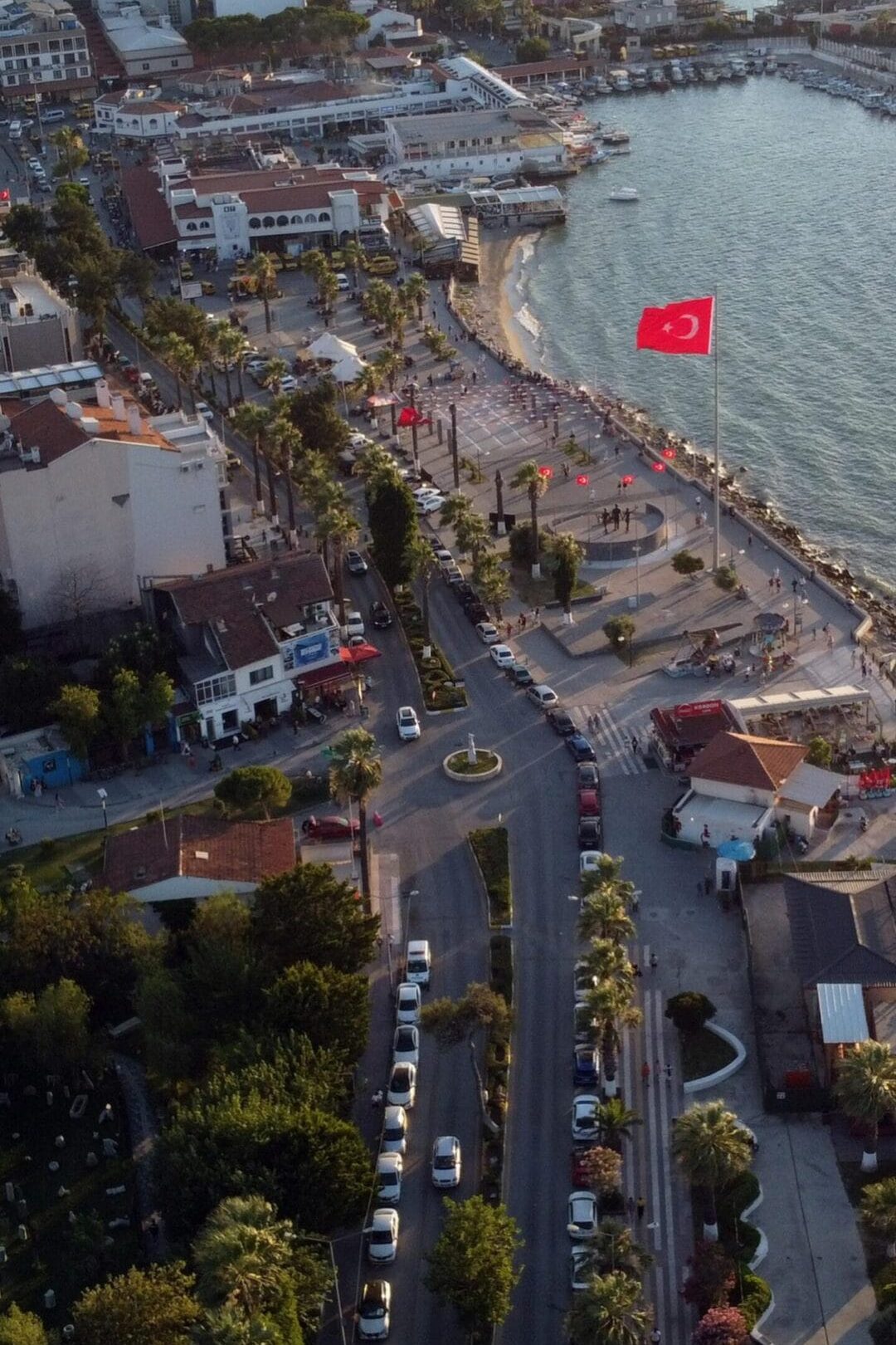 Aerial view of Kuşadası waterfront in Türkiye, showcasing vibrant urban and coastal scene.